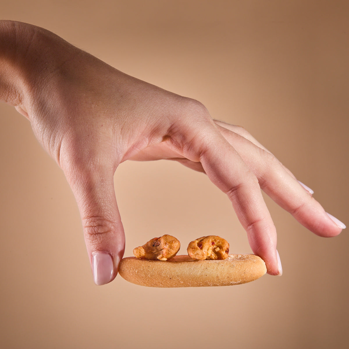 A hand holding Spicy Fusion Truffle Hot Cheese
