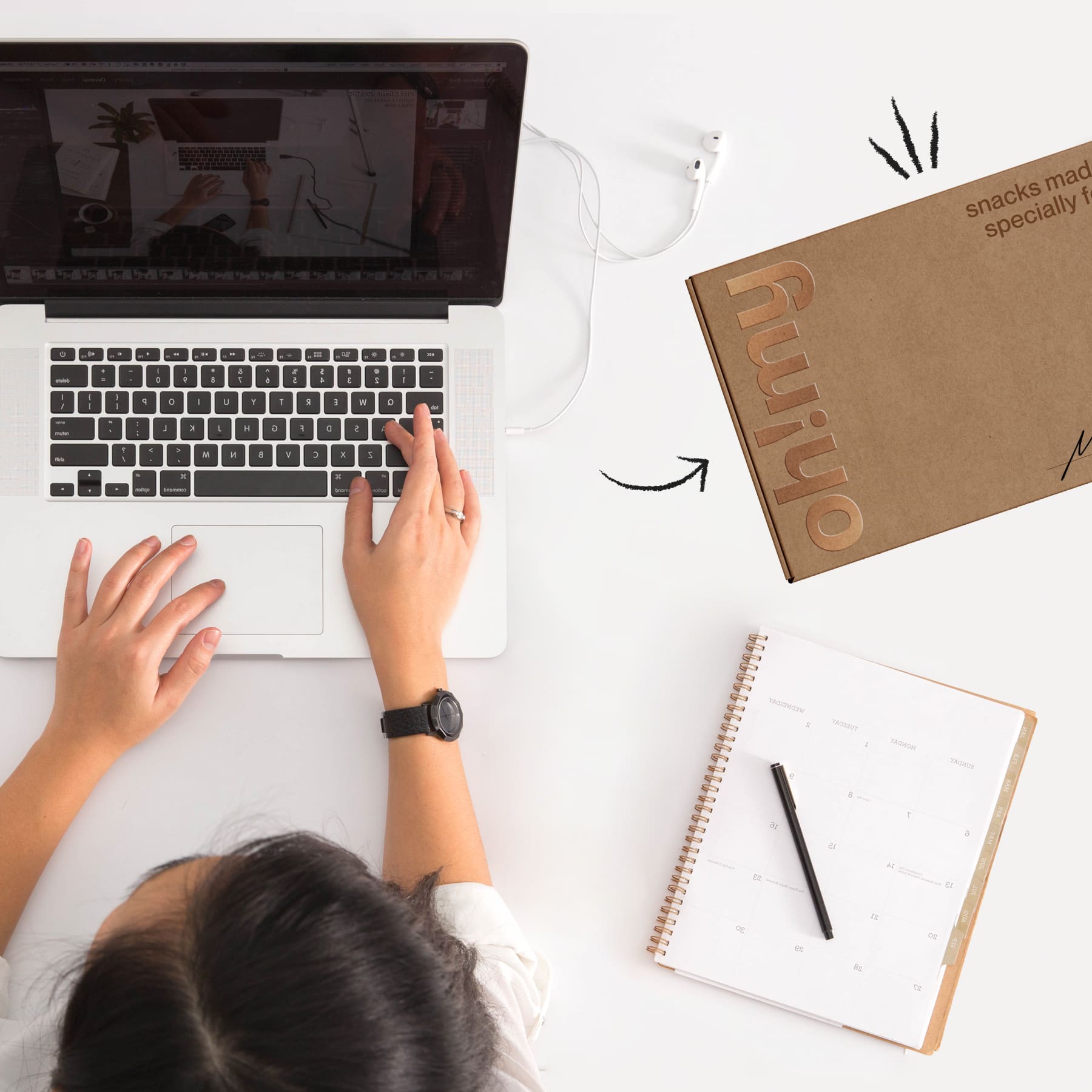 woman working on her laptop with a box of snacks