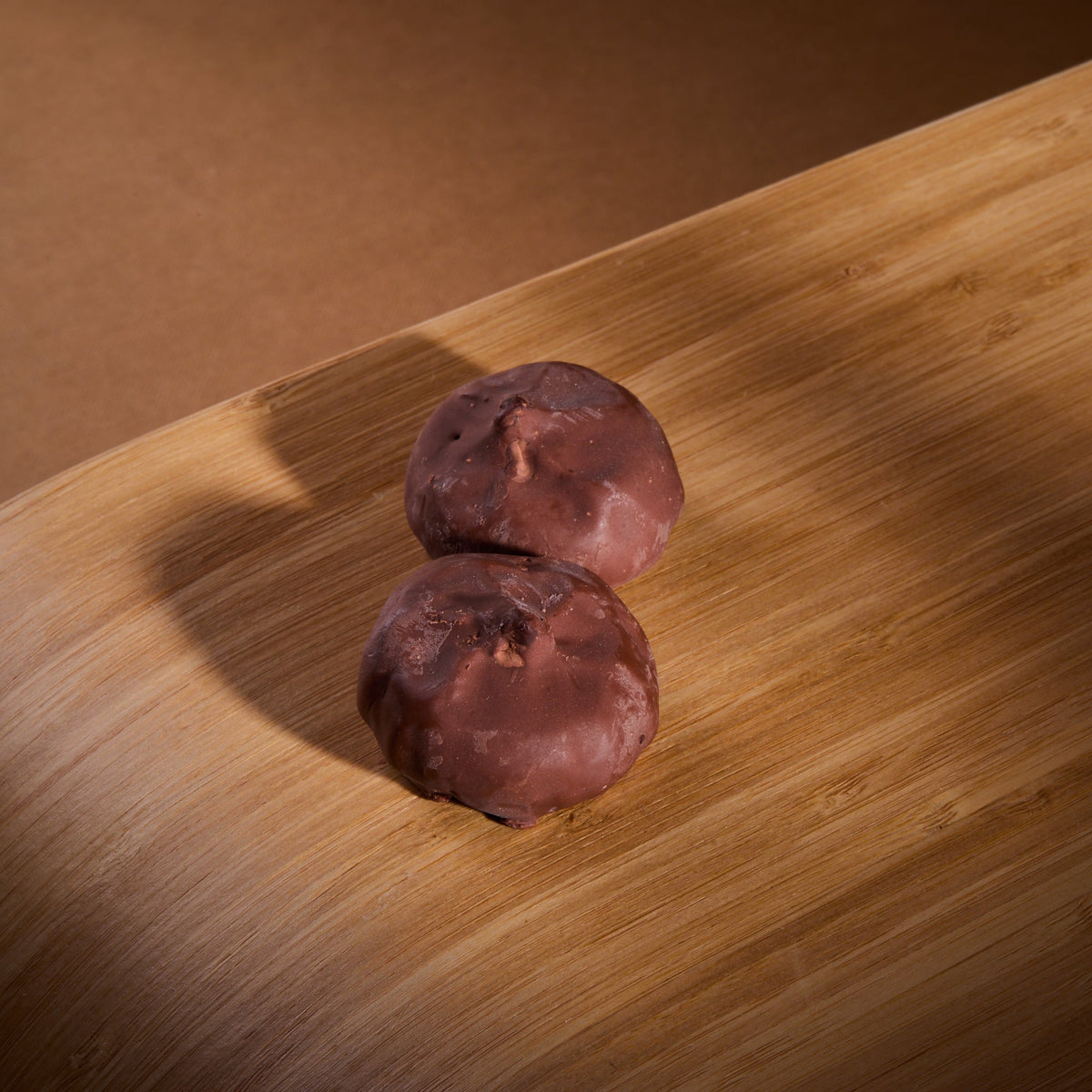 Cocoa Coated Protein Balls Peanut Cream on a wooden board