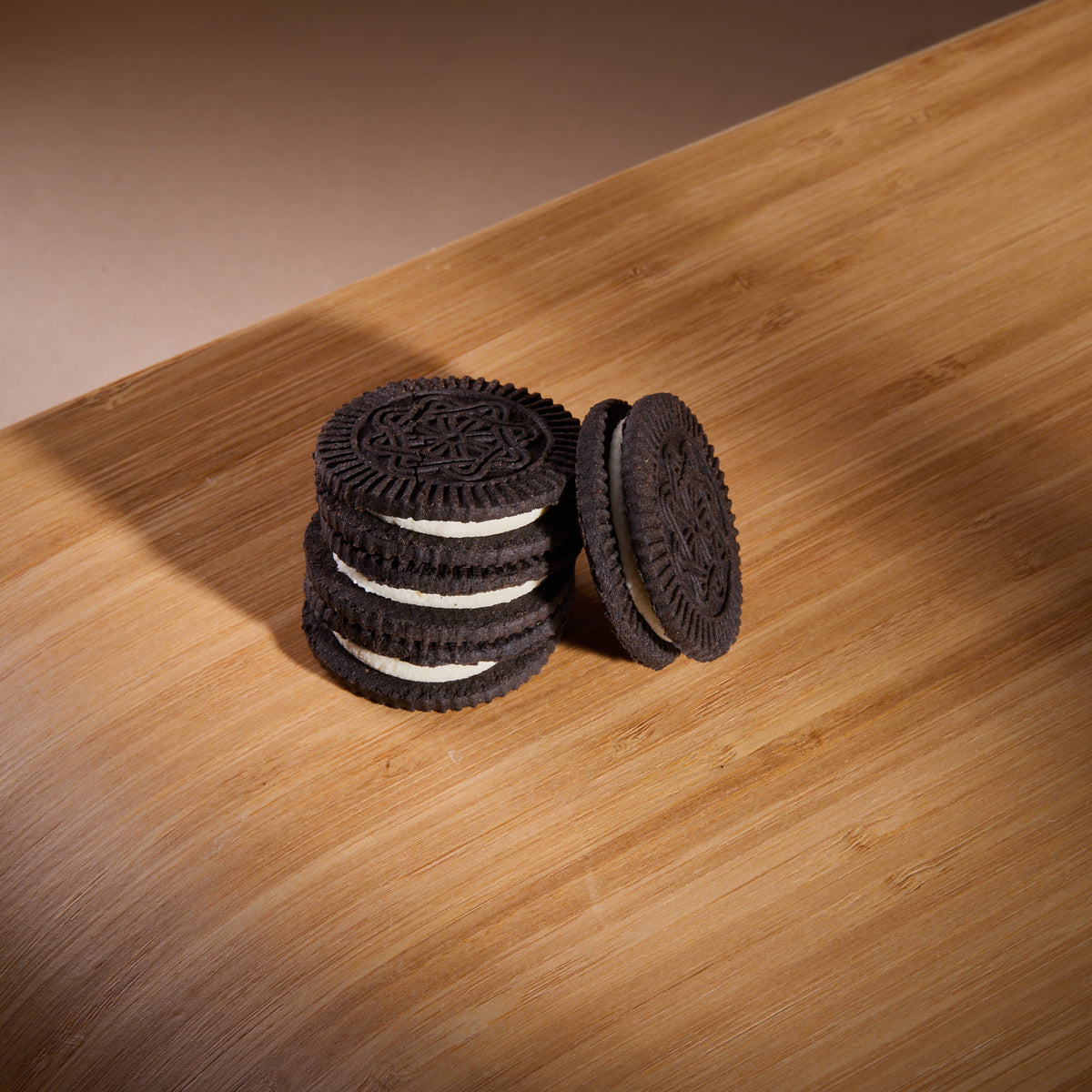 Cocoa Cookies with Vanilla Filling on a wooden board