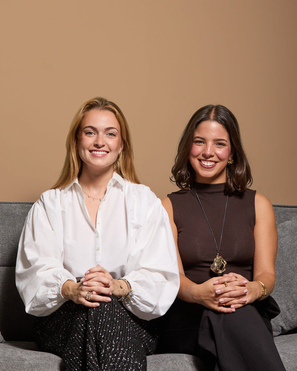 Two of our nutritionists, sitting side by side on a sofa and smiling