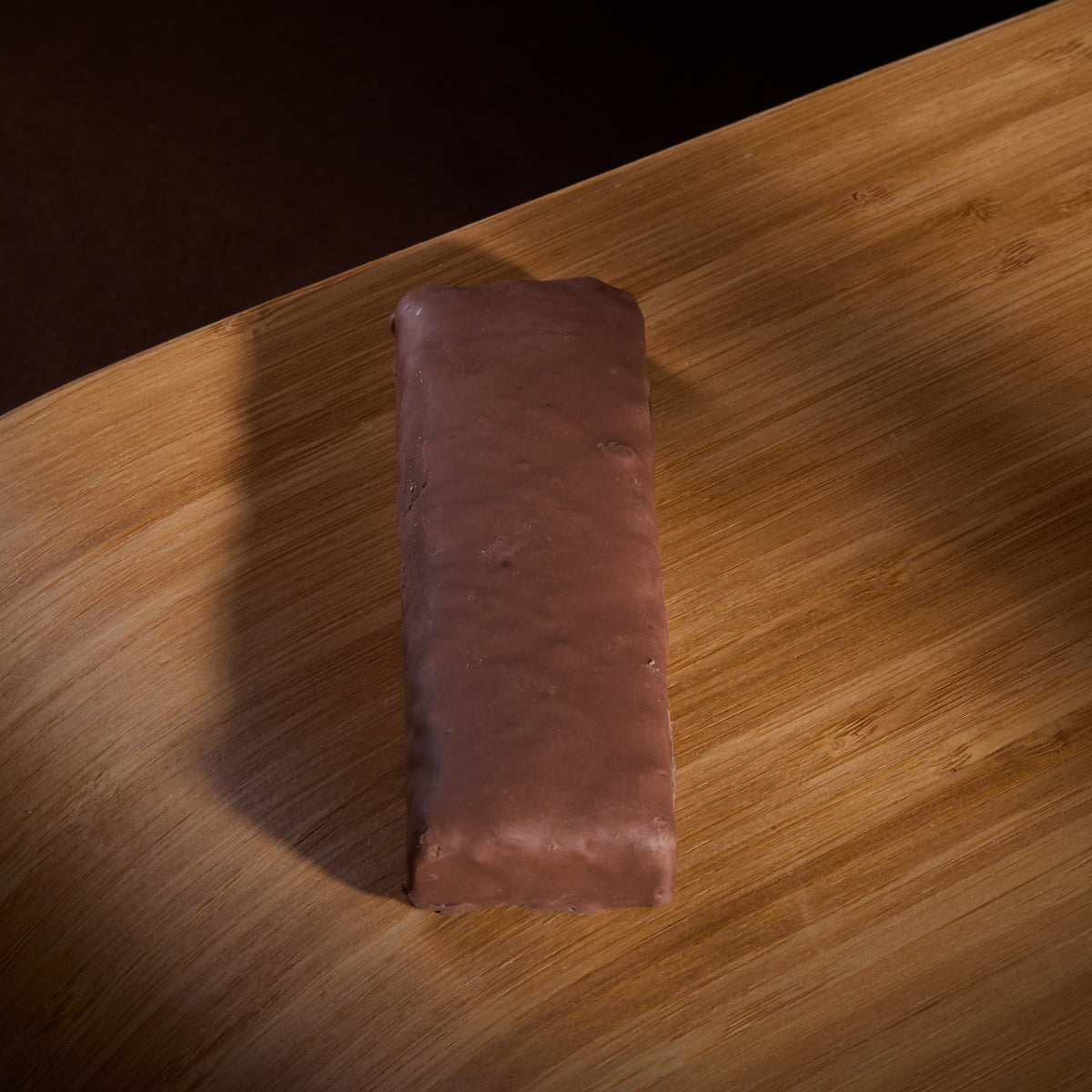 Protein Bar Deluxe Chocolate on a wooden board