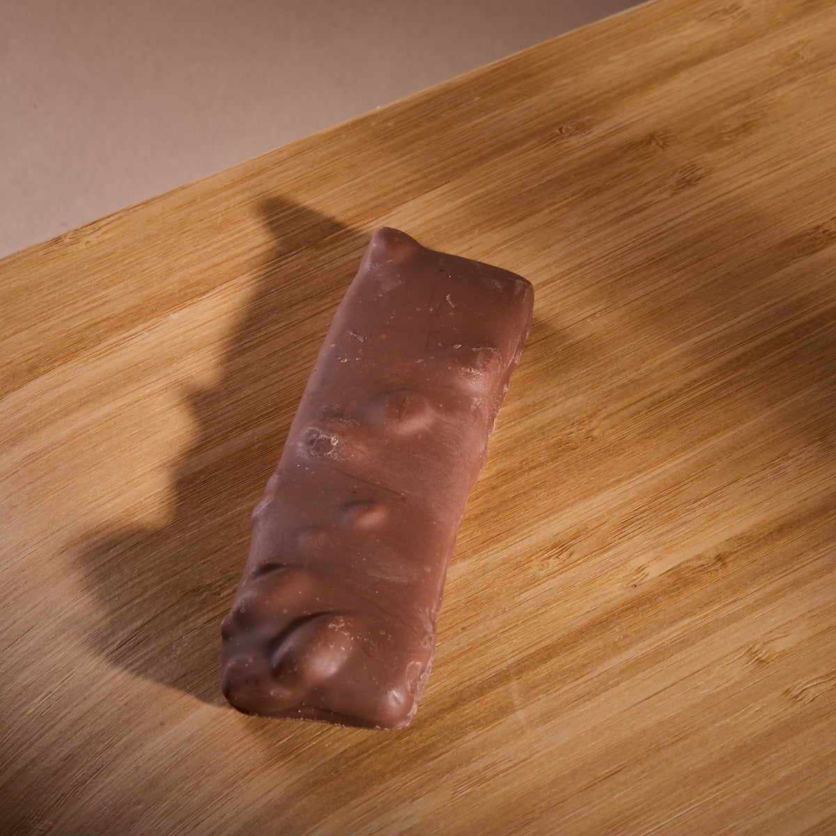 Protein Milk Chocolate with Salted Caramel on a wooden board