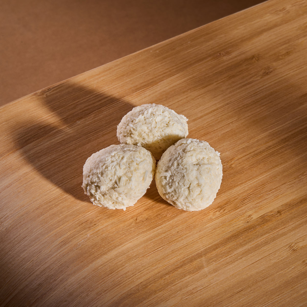 Protein Wafer Balls Almonds and Coconut on a wooden board