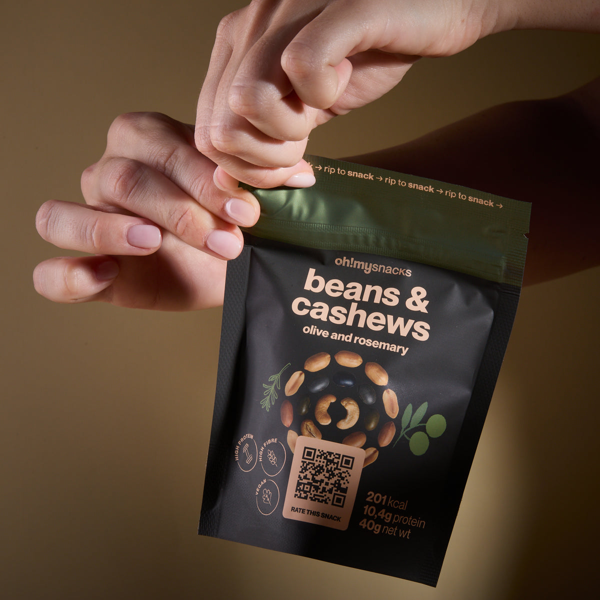 Hands opening a Salty Fusion Beans Olive packet