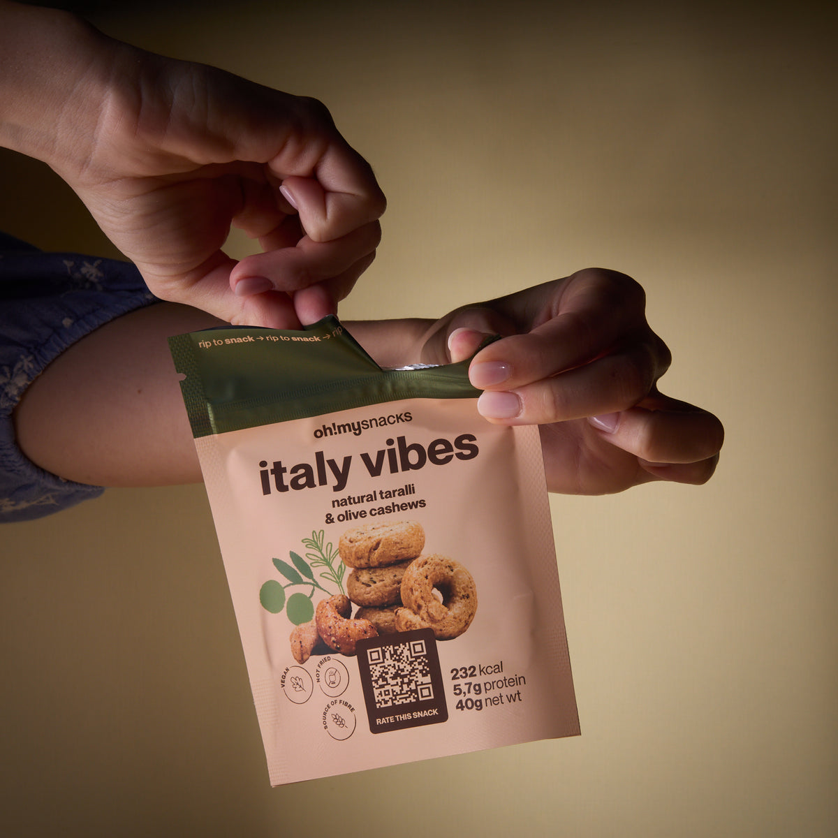 Hands opening a Salty Fusion Italy Vibes packet